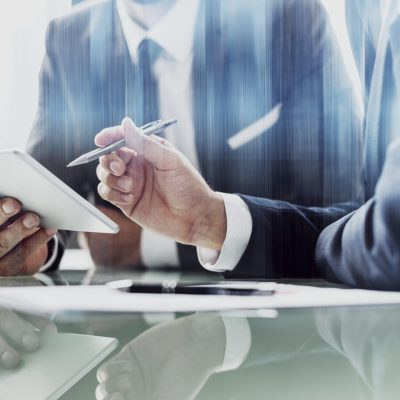 Corporate businessmen working on tablet at office